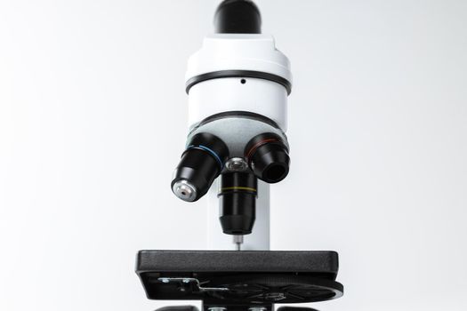 Mo0dern white laboratory microscope on white background, close up