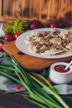 Dumplings, filled with meat and served with fried onion and meat pieces. Varenyky, vareniki, pierogi, pyrohy. Dumplings with filling