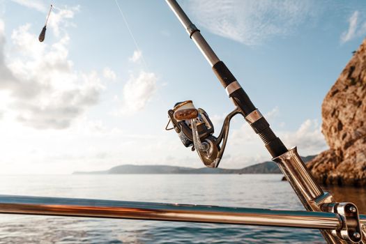 Fishing rod on a sailboat on the background of the open sea