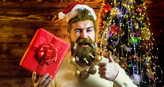 Christmas holidays and winter new year. Portrait of a Santa Claus. Funny happy Santa dressed in winter clothing think about Christmas. Bearded santa
