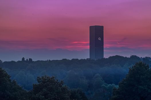 The Telefonica O2 Tower of Munich at a beautiful violett sunset.