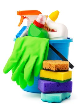 Liquid detergents and cleaning supplies in plastic bucket on white background, close up