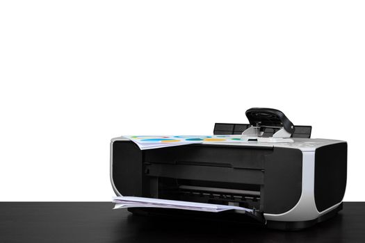 Laser home printer on table against white background, close up