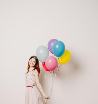 cheerful woman in a dress of colorful balloons. High quality photo