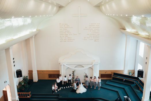 SACRAMENTO, USA - MAY 12 th 2018: Bride and groom pray and receive blessings in the church building.