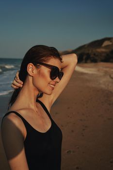 cheerful woman sunglasses posing black swimsuit island. High quality photo