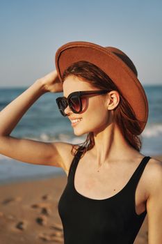 cheerful woman in sunglasses Sandy coast landscape sun. High quality photo