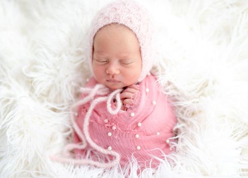 Lovely sleeping newborn in knitted hat