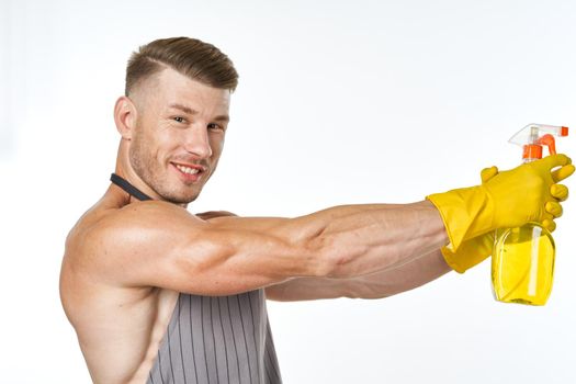 man wearing apron detergent cleaning posing service. High quality photo