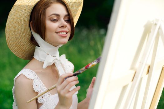 woman artist paints a picture outdoors easel creative. High quality photo