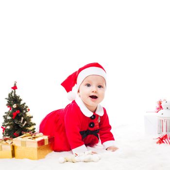 Santa baby girl with gift box and christmas decorations on a fur