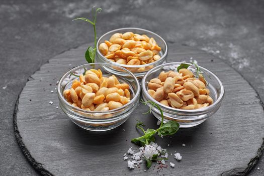 Roasted peanuts with salt, for beer, on a dark background