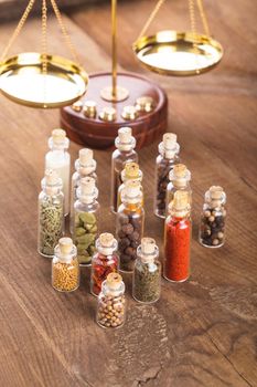 Little bottles with spices and scales on the table