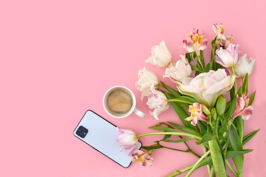 White cup of coffee with tulip and smartphone on pink background copy space