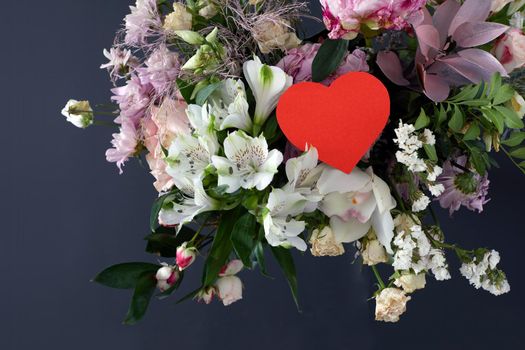 Valentines day greeting paper heart card with rose flowers bouquet dark background with space for your greetings. Top view flat lay