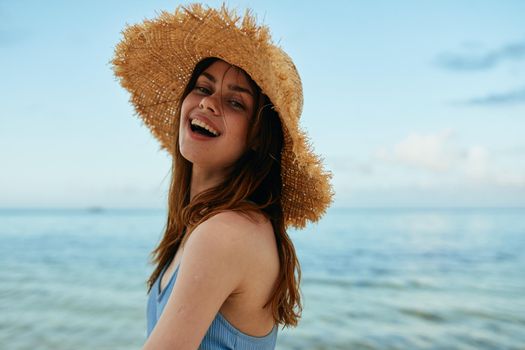 cheerful woman in a beach hat by the ocean island summer. High quality photo