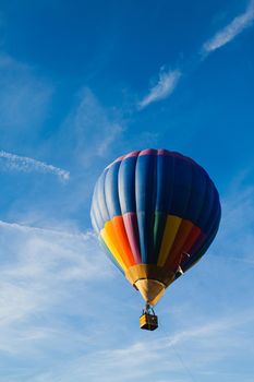 Colorful hot air balloon in blue sky at sunset