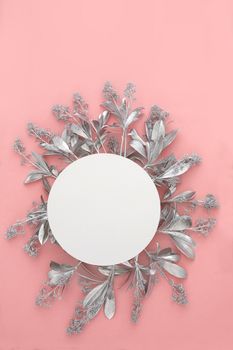 Blank paper card mockup with silver flowers. Holiday concept with place for text on a pink pastel background