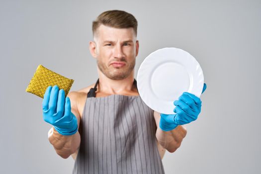 male athlete in aprons washing dishes service. High quality photo
