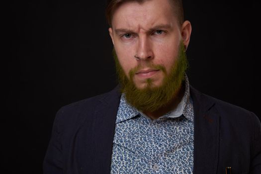 fashionable business man in a jacket with a beard posing. High quality photo