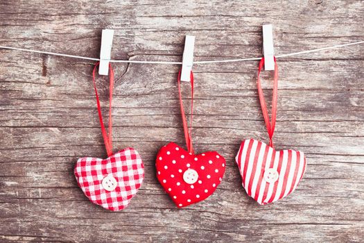 White and red sewed christmas hearts attached to the rope. Holiday background for greetings Valentine's day