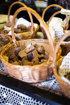 Chocolate shop. Pieces of natural product in baskets