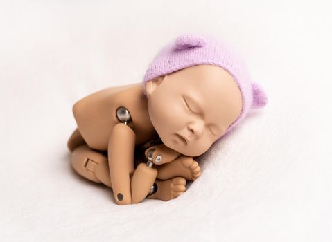 Realist puppet of newborn child in taco stand with hat, isolated on white background