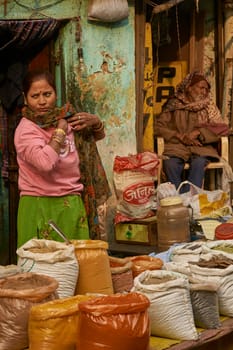 DELHI, INDIA - FEBRUARY 5, 2009: Lady selling spices in a street market in Old Delhi, India