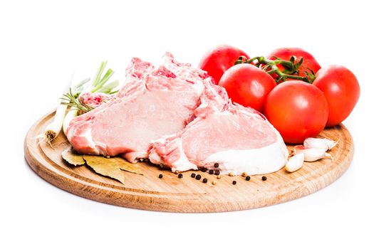 Raw loin slices on the board isolated on white