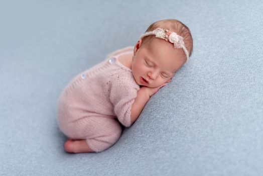 Lovely newborn sleeping comfortable on stomach