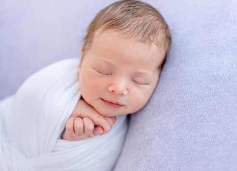 Lovely newborn smiling in dream