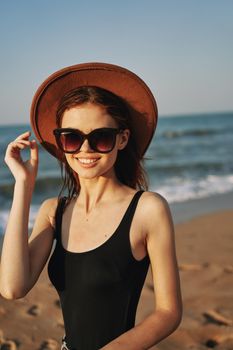 cheerful woman in sunglasses Sandy coast landscape sun. High quality photo