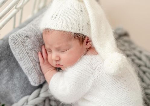 Beautiful newborn sleeping on tiny bed