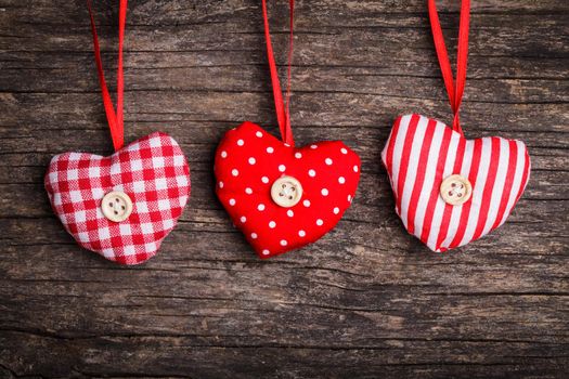 White and red sewed christmas hearts attached to the rope. Holiday background for greetings Valentine's day