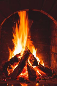 Burning fire in the brick fireplace, close up