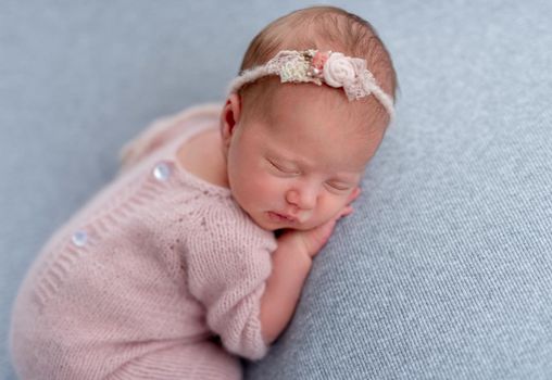 Lovely newborn sleeping comfortable on stomach