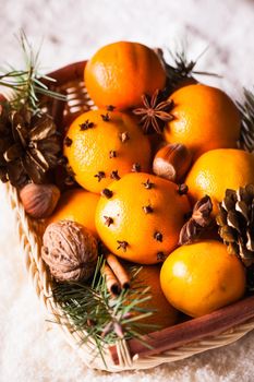 Christmas basket - fir, tangerins and spices on the snow