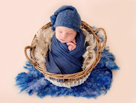 Charming newborn sleeping in basket