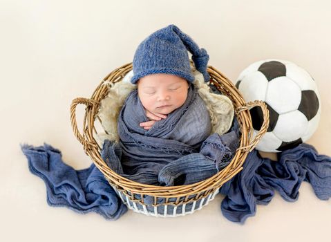 Adorable newborn resting in basket
