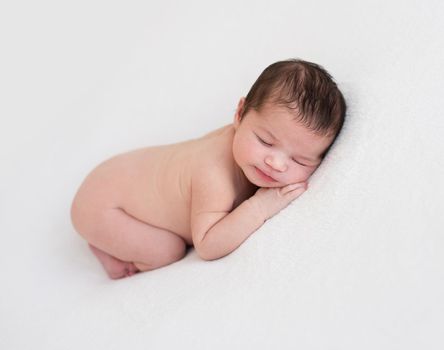 Innocent newborn sleeping on stomach