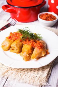 Stuffed cabbage with tomato dip on the plate