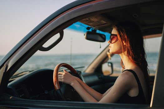pretty woman in sunglasses driving a car trip. High quality photo