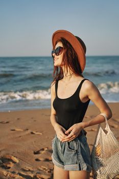 woman in trendy summer clothes by the ocean vacation sun. High quality photo