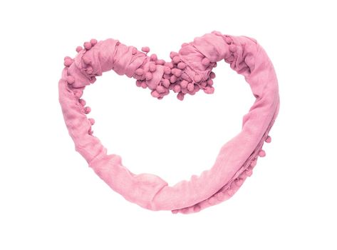 Frame in the shape of a heart of twisted delicate fabric of pink color isolated on white background.