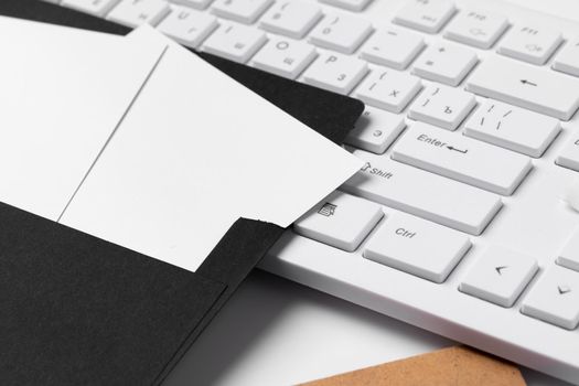 Blank business cards with supplies and keyboard on office table. Close up.