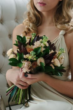 Woman in beautiful dress holding flower bouquet in hands