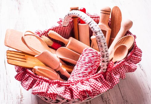 Shabby chic rustic basket with wooden kitchen utensils