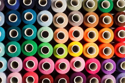 Sewing threads as a multicolored background close up