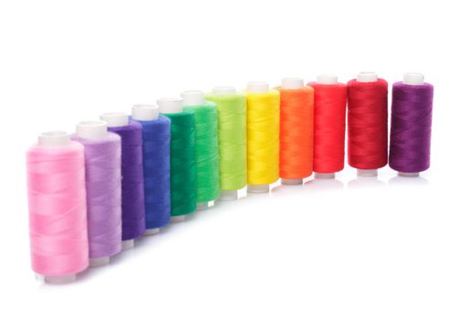 Sewing multicolored threads isolated on a white