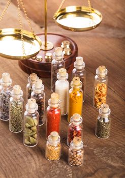 Little bottles with spices and scales on the table